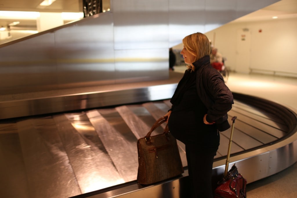 Samantha Brown waits for her luggage at the baggage claim